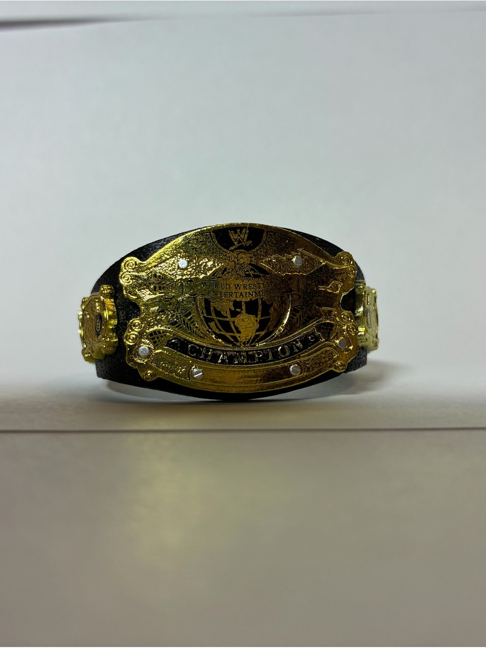 WWE Gold Plate Championship Belt on Black Strap